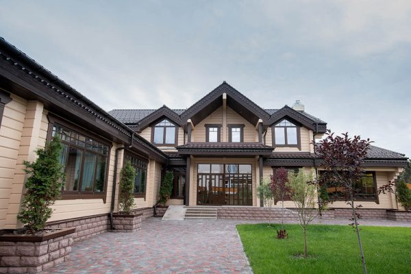 Exterior of modern comfortable cottage or house with front yard